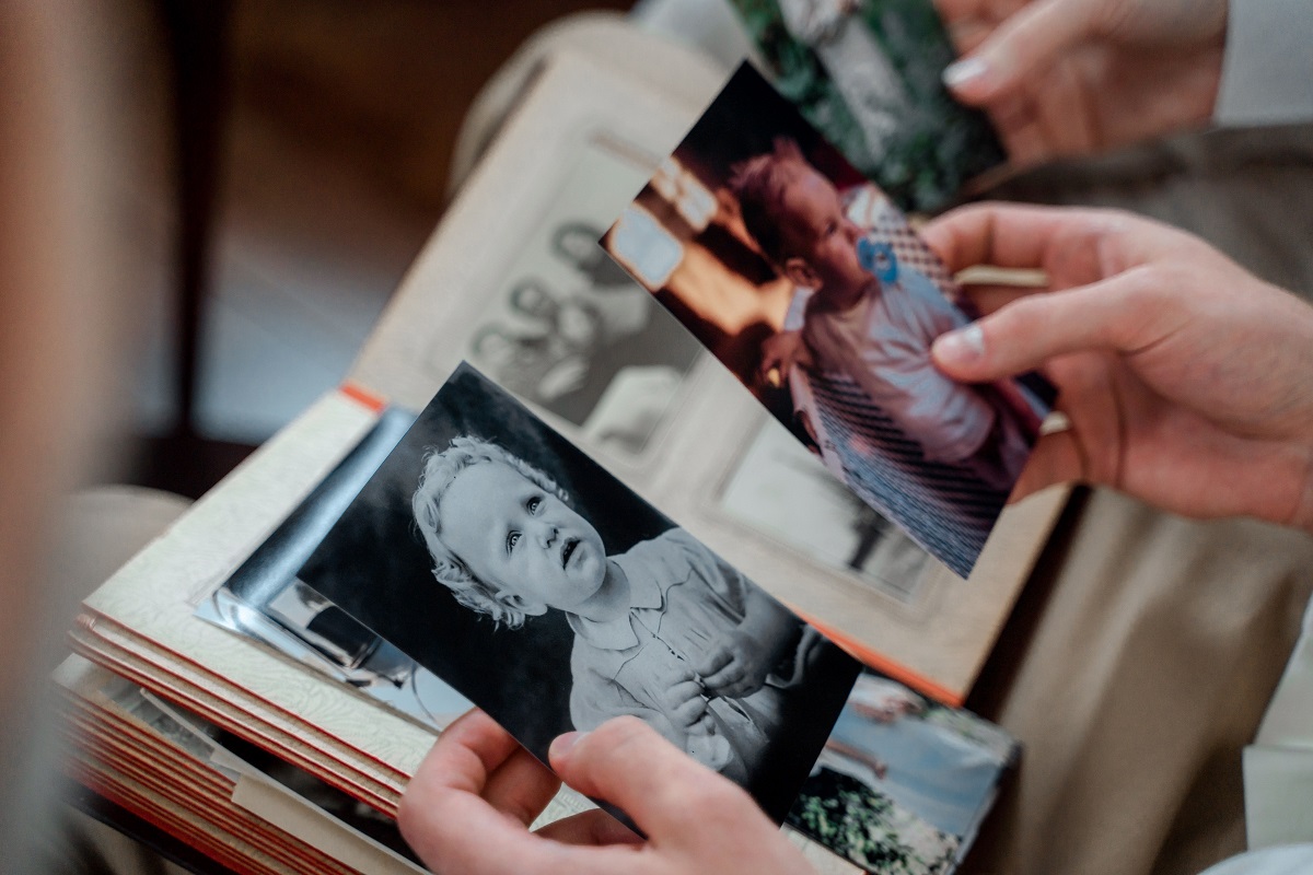 Manos revisando fotografías familiares antiguas - herencia y recuerdos familiares en Torrent